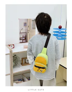 Detail view of colorful crossbody chest bag with front pocket and contrast strap on child