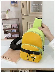 Detail of green and yellow nylon crossbody bag featuring front pocket and woven strap