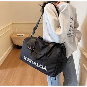 Large capacity black travel duffel bag with white letter print and adjustable shoulder strap