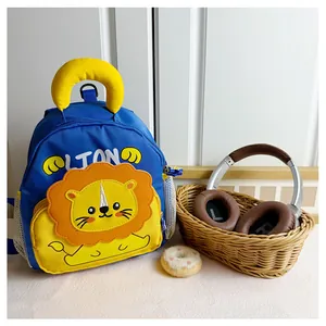 Detail view of cartoon lion backpack featuring mesh side pocket and soft top handle
