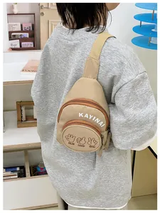 Close-up of khaki canvas chest bag with gesture illustrations and adjustable strap