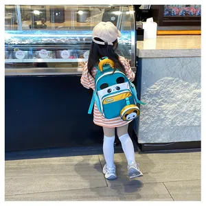 Kid wearing blue-green panda backpack with round panda coin purse in a dessert shop