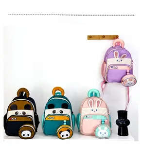 Detail of four colorful animal backpacks with matching mini round pouches on wall hooks