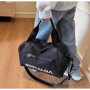 Close-up of black sports duffel bag showing high-quality waterproof nylon fabric and handles
