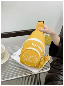 Close-up of vibrant yellow kids canvas crossbody bag with white gesture prints