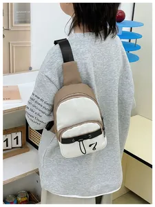 Close-up of khaki and cream color block crossbody bag with drawstring detail