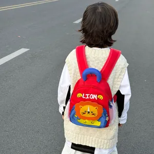 Red preschool backpack with a cute cartoon lion and breathable side mesh pockets