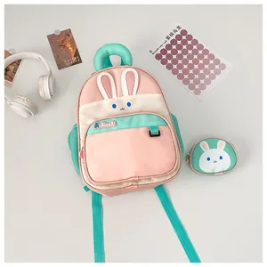 Detailed view of pink and green bunny backpack with 3D ears and side mesh pocket