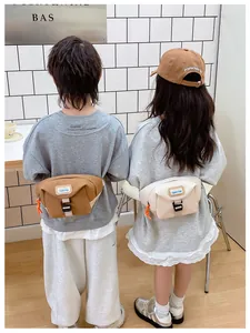 Kids chest bags in brown and cream shown on children for size and style reference