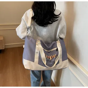 Large lavender canvas travel bag with Hope lettering shown on a model's shoulder
