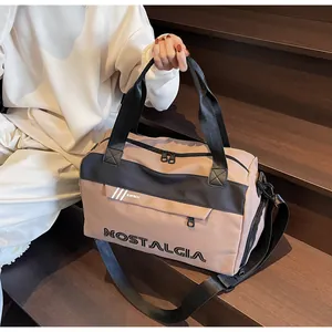 Detail of khaki travel bag showing side pocket, shoulder strap, and logo print
