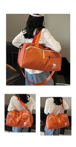 Detalle de bolsa deportiva naranja en nailon impermeable con logo P Kayinai y correa