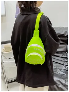 Detail of neon green canvas chest bag with white KAYINAI lettering and adjustable strap
