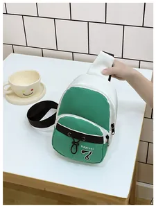 Detail of green and white color-block mini crossbody bag with multiple zipper pockets