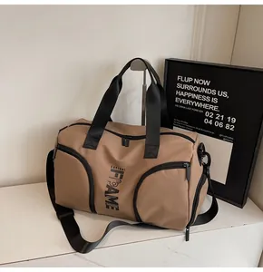 Dettaglio borsa fitness kaki con doppie tasche a zip e cinghie nere rinforzate