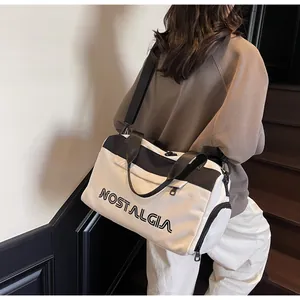 Macro detail of large travel tote bag featuring black and white contrast and letter print