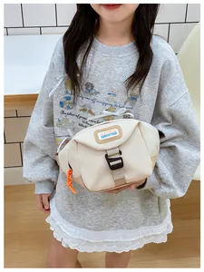 Close-up of kids' cream canvas waist bag with adjustable strap and orange zipper