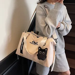 Large capacity beige travel bag with cat graphics and cute plush kitty charm