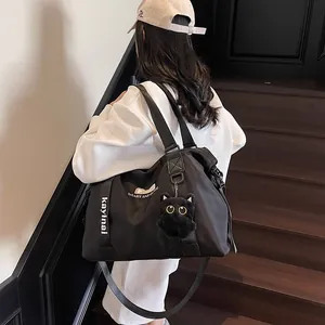 Large capacity black nylon travel bag with cute cat ears and plush keychain