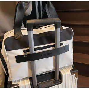 Detail of trolley sleeve design on black travel bag attached to a white suitcase handle
