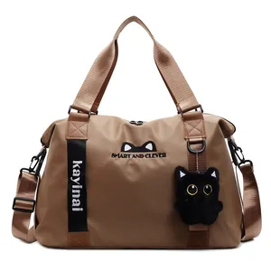 Large brown travel bag with cute cat ears embroidery and a plush kitten pendant