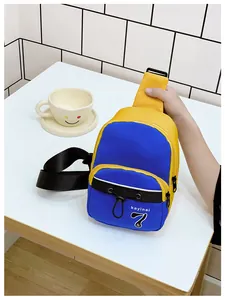 Detail of blue and yellow kids crossbody bag with adjustable strap and decorative drawstrings