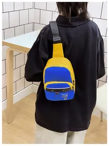 Detail of blue and yellow nylon crossbody bag featuring adjustable straps and logo