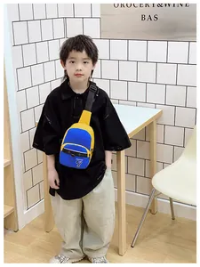 Detail of kids crossbody bag featuring blue and yellow color block and adjustable strap
