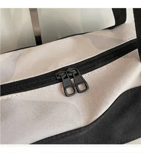 Detail of smooth double-ended black metal zipper on durable travel duffel bag