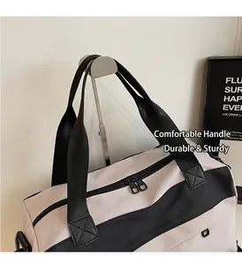 Detail of canvas travel bag featuring durable black handles and sturdy double zippers