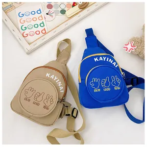 Close-up of stylish canvas chest bags with trendy letter prints and adjustable straps