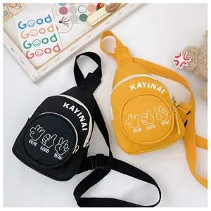 Detail of mini canvas chest bags in black and yellow with adjustable straps and zipper pockets