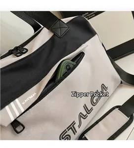 Detail of side zipper pocket on canvas travel bag showing storage capacity for a phone