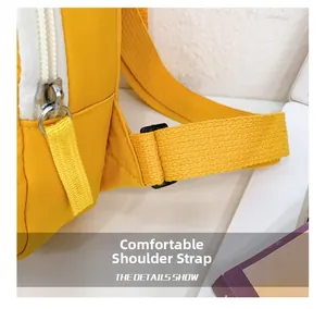 Detail of yellow canvas kids crossbody bag featuring adjustable strap and buckle