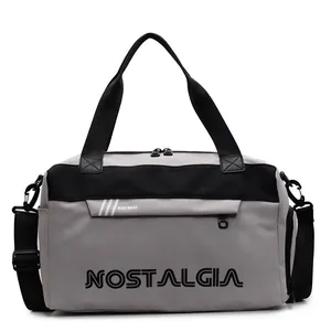 Grey and black large travel duffle bag with letters and adjustable shoulder strap