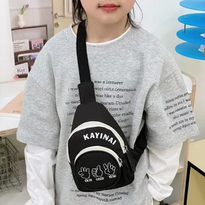 Minimalist black canvas chest bag for children featuring white letter print and adjustable strap