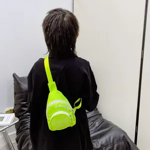 Neon green stylish kids crossbody bag with white letters worn by a child on back