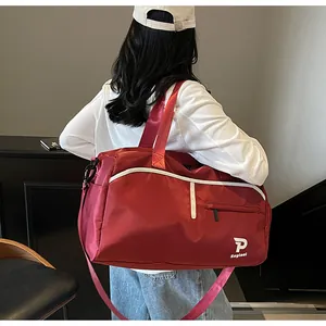 Detalle de bolsa de deporte roja impermeable con borde blanco y correa ajustable