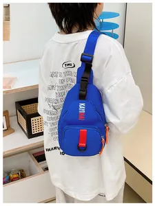 Close-up of blue kids crossbody chest bag with adjustable strap and logo print