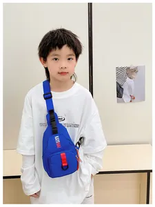 Blue kids chest bag with Kayinai lettering and red straps worn by a young boy