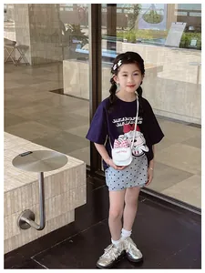 Detailed view of white mini crossbody bag with pink plaid bow on a girl summer outfit