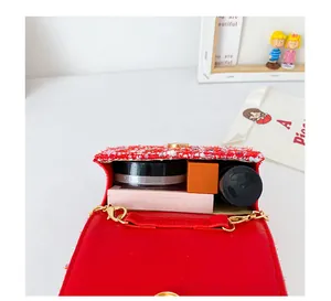 Détail intérieur du sac en tweed rouge pour fille avec rangement et chaîne dorée