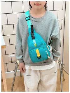 Detail of teal waterproof nylon kids crossbody bag featuring yellow KAYINAI text