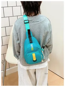 Rear view of a child wearing a trendy cyan blue nylon chest bag with yellow strap detail