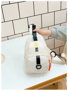 Detail of white fashion chest bag featuring bold letter print and orange zipper accents