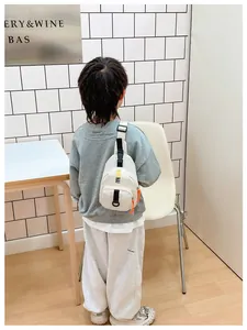 White casual kids chest bag featuring black letter print and vibrant orange zipper details