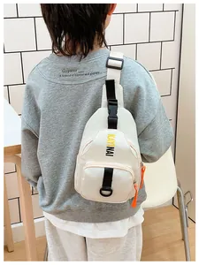 Detail of white kids chest bag featuring letter print and contrast orange zipper pulls