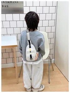 Rear view of a child wearing a white casual chest bag with adjustable strap and buckle