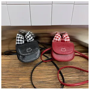Detailed view of mini PU leather crossbody bags with bows and embossed cat patterns