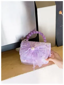 Detail of purple lace kids handbag with gauze bow, pearl center and star accents